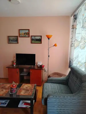 a living room with two couches and a flat screen tv at Apartman Domina in Kruševac