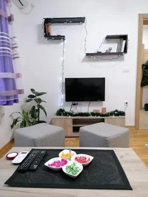 a living room with a table with bowls of food at Apartman San in Vrnjačka Banja