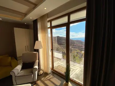 a room with a chair and a window with a view at Milmari Mountain view - I11 in Kopaonik