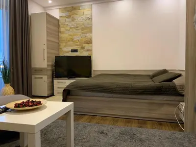 a bedroom with a bed and a tv and a table at Milmari Mountain view - I11 in Kopaonik