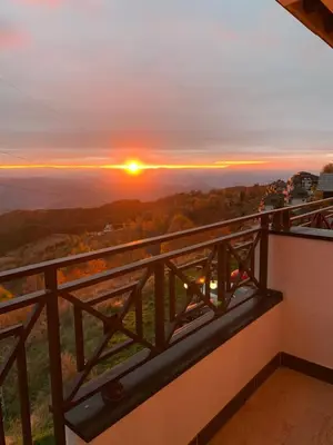 a sunset from the balcony of a house at Milmari Mountain view - I11 in Kopaonik