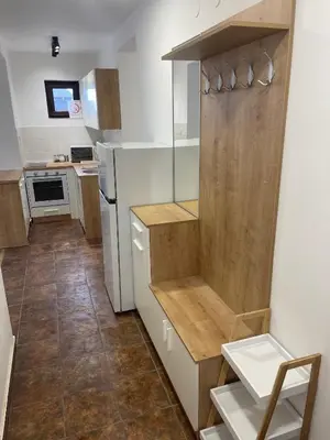 a small kitchen with white appliances and wooden cabinets at Desetka Kopaonik in Kopaonik