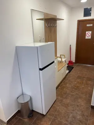 a white refrigerator in a room with a trash can at Desetka Kopaonik in Kopaonik