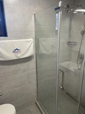 a shower with a glass door in a bathroom at Desetka Kopaonik in Kopaonik