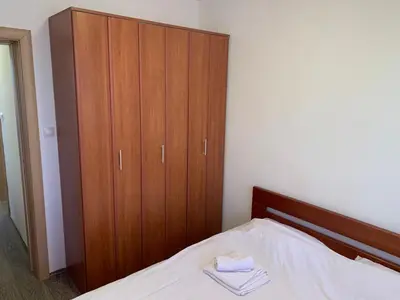 a bedroom with a bed with a wooden cabinet at Desetka Kopaonik in Kopaonik