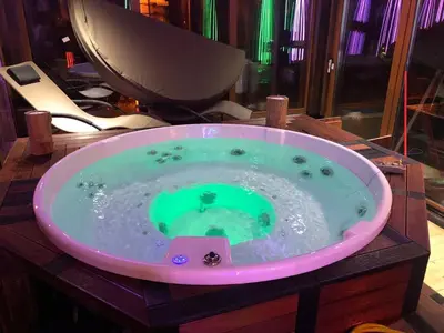 a jacuzzi tub with a green liquid in it at K2 Chalet in Kopaonik