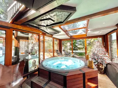 a jacuzzi tub in a room with windows at K2 Chalet in Kopaonik