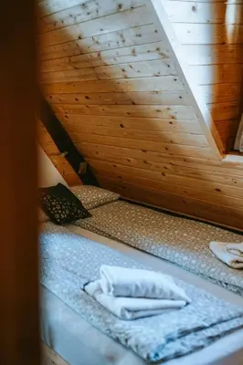 a sauna with two white towels on a bed at K2 Chalet in Kopaonik