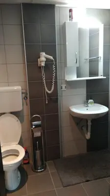 a bathroom with a toilet and a sink and a phone at Lux Apartman Ristić 1 in Soko Banja