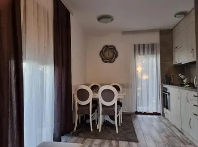 a kitchen with a table and chairs in a room at Vila Rajski kutak Kopaonik in Kopaonik