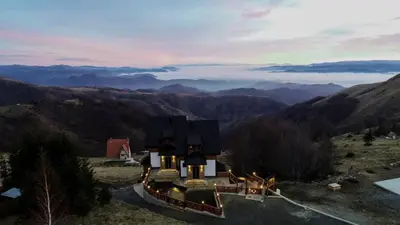 a house on a hill with a view of mountains at Vila Rajski kutak Kopaonik in Kopaonik