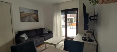 a living room with a couch and a table at Vila Irina Kopaonik - Apartman Jovana in Kopaonik