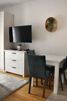 a white desk with a television and a chair at Vila Irina Kopaonik - Apartman Jovana in Kopaonik