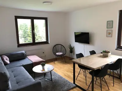 a living room with a couch and a table at Vila Irina Kopaonik - Apartman Jovana in Kopaonik