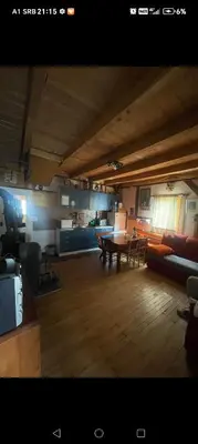 a large living room with a table and a couch at kuća za odmor marković in Kopaonik