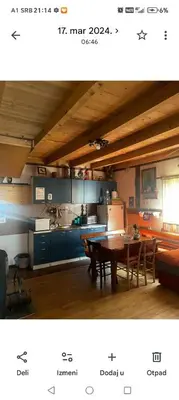 a kitchen and a dining room with a table at kuća za odmor marković in Kopaonik
