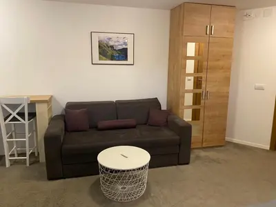a living room with a couch and a table at Vuk & Sofija Apartmani in Kopaonik