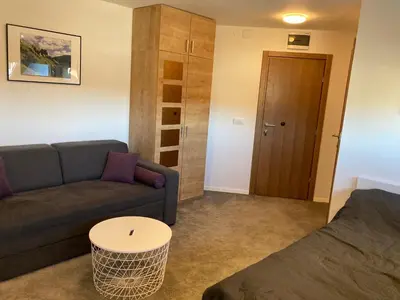 a living room with a couch and a table at Vuk & Sofija Apartmani in Kopaonik