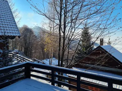 a balcony with snow on the railing of a house at Mountain House Mijatović in Kopaonik