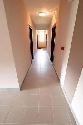 a hallway of a building with a long corridor at Lux Apartman Ristić 2 in Soko Banja
