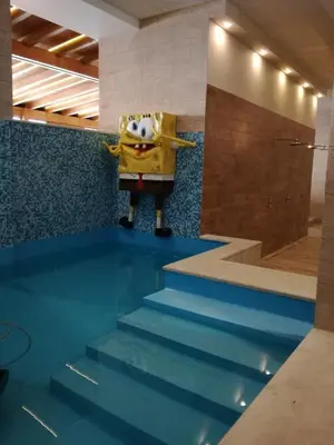 a cartoon character standing on top of some stairs at Apartman Div Kopaonik in Kopaonik