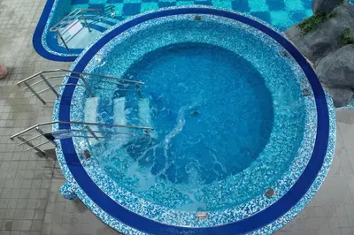 a swimming pool with blue water in it at Spa Resort & Hotel Vrnjačke Terme in Vrnjačka Banja