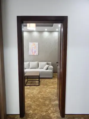 a living room with a couch through a mirror at Spa Resort & Hotel Vrnjačke Terme in Vrnjačka Banja
