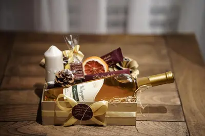 a gift box with a bottle of wine and a candle at FeelSTONE apartmani Brzeće in Brzeće