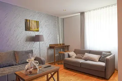 a living room with a couch and a table at FeelSTONE apartmani Brzeće in Brzeće