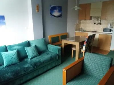 a living room with a couch and a table at Kopaonik Vila Nikola 306 centar in Kopaonik