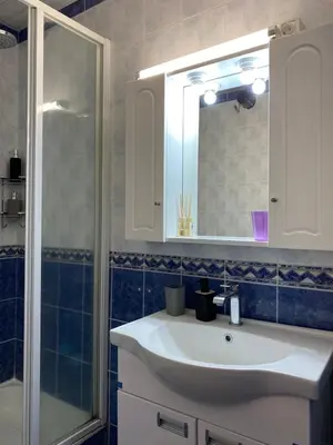 a bathroom with a sink and a shower and a mirror at Kopaonik Vila Nikola 306 centar in Kopaonik