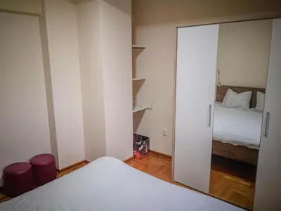 a bedroom with a mirror and a bed at STAR apartman Brzece Kopaonik in Brzeće