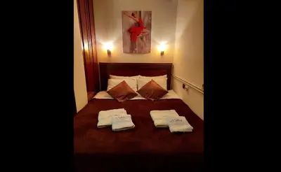 a bedroom with a bed with two towels on it at Apartman Vrhovi Kopaonik Vila Nikola Centar in Kopaonik