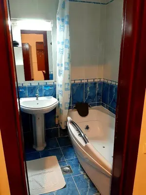 a bathroom with a tub and a sink and a bath tub at Apartman Vrhovi Kopaonik Vila Nikola Centar in Kopaonik