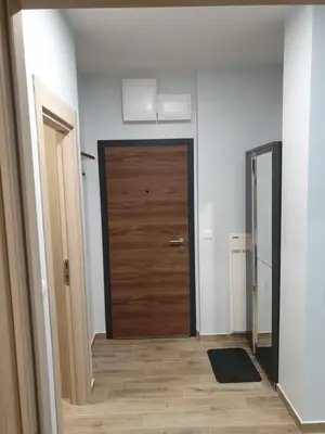 a hallway with a wooden door in a room at Apartman Noalux Kopaonik in Kopaonik
