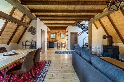 a living room with a blue couch and a fireplace at Kežman Mountain Houses in Kopaonik
