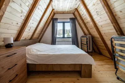 a bedroom with a bed in a attic at Kežman Mountain Houses in Kopaonik