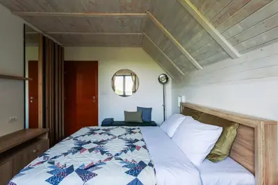 a bedroom with a bed with a quilt on it at Kežman Mountain Houses in Kopaonik