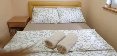 a bed with two towels on top of it at Apartman Nikola- 4 ZVEZDICE minimalno 3 nocenja za rezervaciju in Vrnjačka Banja