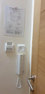 a phone hanging on a wall next to a door at Apartman Nikola- 4 ZVEZDICE minimalno 3 nocenja za rezervaciju in Vrnjačka Banja