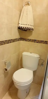 a bathroom with a white toilet and a towel at Apartman Nikola- 4 ZVEZDICE minimalno 3 nocenja za rezervaciju in Vrnjačka Banja