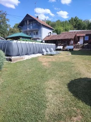 a group of chairs in a yard next to a house at Apartmani Mihajlovic Sisevac in Sisevac