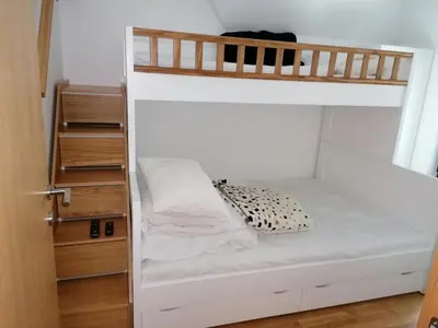 a white bunk bed with a black and white pillow on it at Vila Irina Kopaonik in Kopaonik