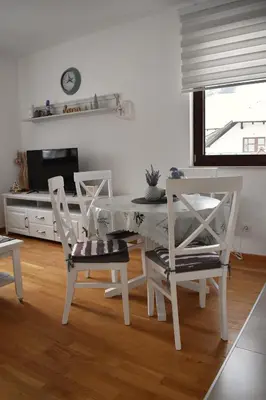 a white dining room with a table and chairs at Vila Irina Kopaonik in Kopaonik