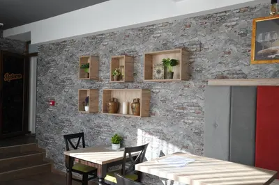 a restaurant with two tables and a brick wall at Milmari Resort - Lux Apartment in Kopaonik