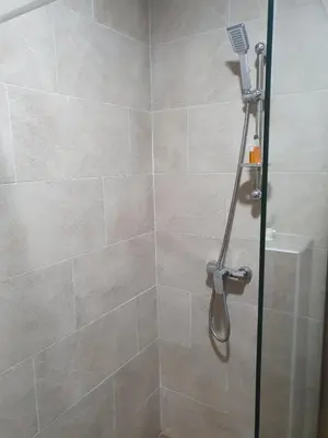 a shower with a glass door in a bathroom at Milmari Resort - Lux Apartment in Kopaonik