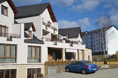 a blue car parked in front of a building at Milmari Resort - Lux Apartment in Kopaonik
