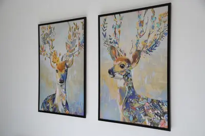 three framed paintings of deer on a wall at Milmari Resort - Lux Apartment in Kopaonik