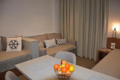 a living room with a bowl of fruit on a table at Apartman SREBRNA PAHULjA-Konaci in Kopaonik
