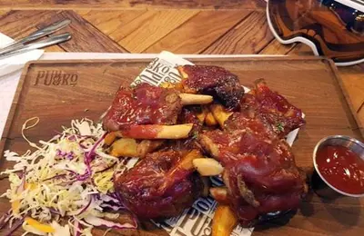 a plate of food with meat and a salad at Apartman SREBRNA PAHULjA-Konaci in Kopaonik